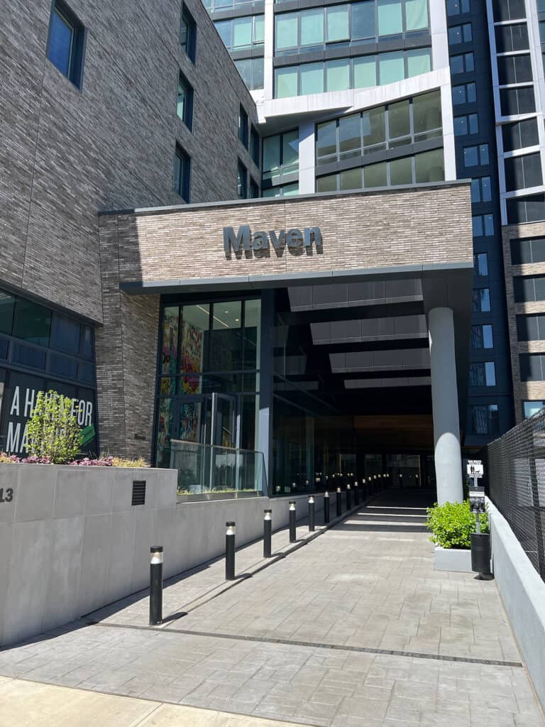 The entrance to The Maven. The building's signage features a DURUS brick facade.